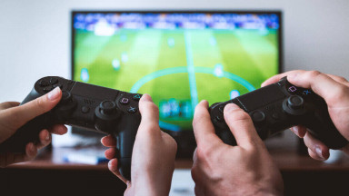 Friends playing FIFA on PlayStation