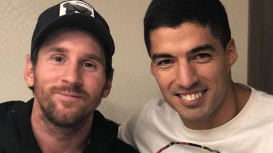Messi and Suarez smiling for a photo